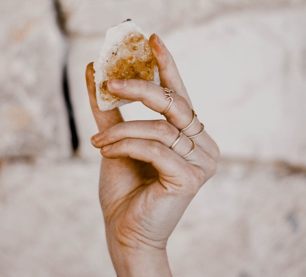Hand holding Citrine crystal.
